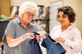 Textile Tutor and Learner holding up fabric