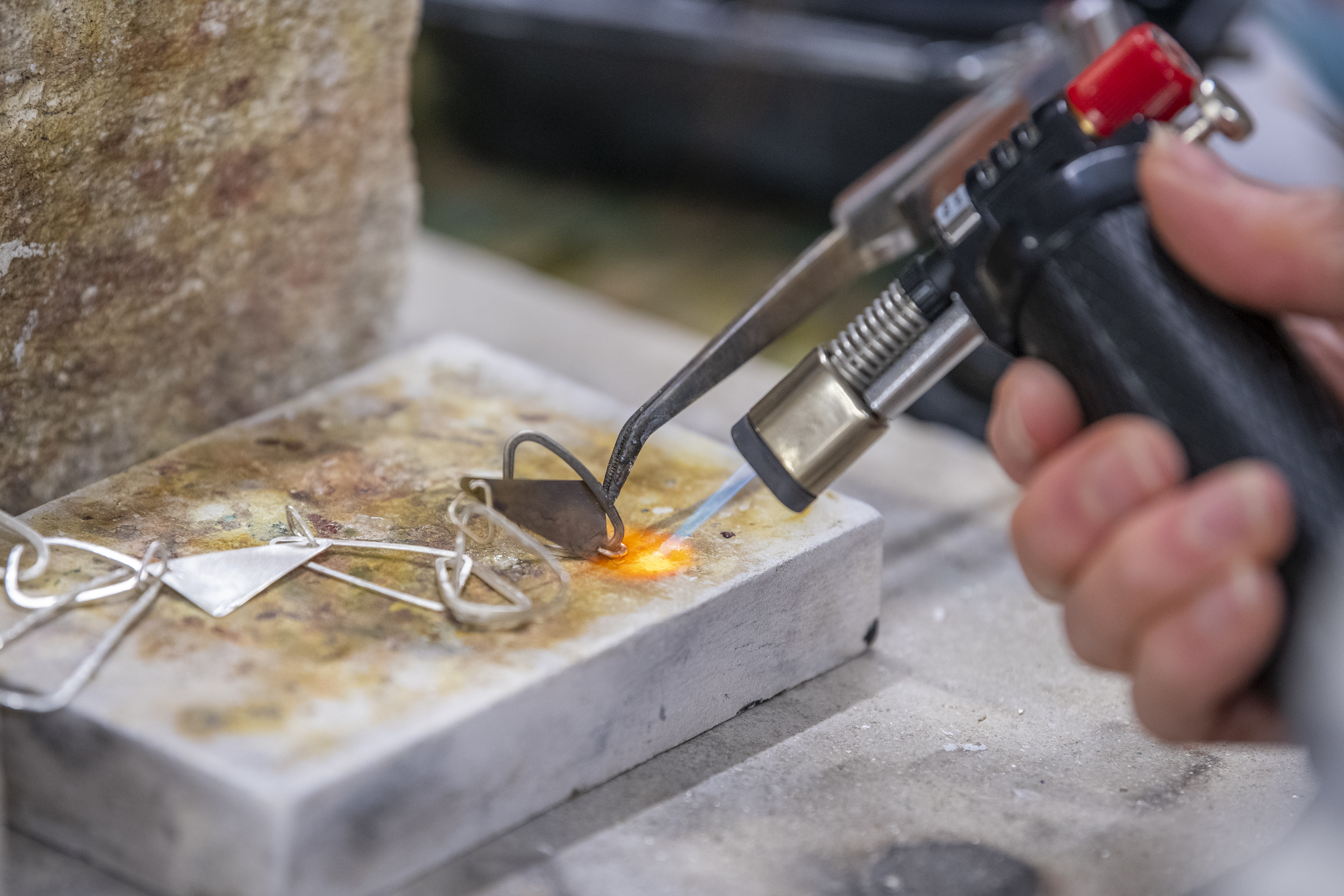 Learner creating jewellery with a fire gun