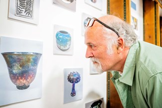 Male learner admiring his pottery piece